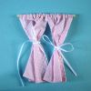 Pair Of Pink Gingham Curtains On Pole
